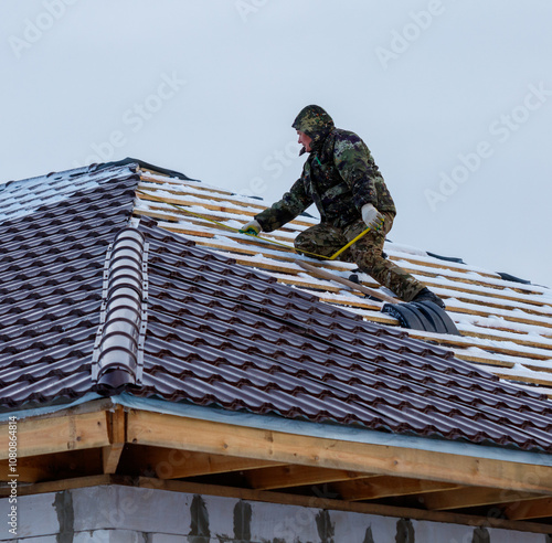 Wallpaper Mural A man in camouflage is working on a roof Torontodigital.ca