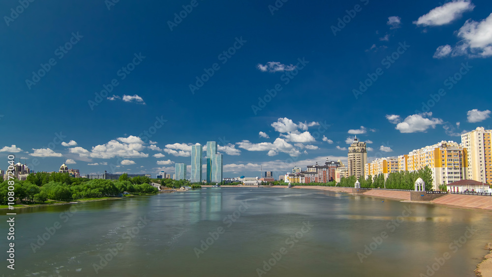 Obraz premium Yesil river timelapse hyperlapse with modern towers of residential complex in Astana