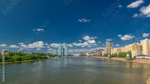 Yesil river timelapse hyperlapse with modern towers of residential complex in Astana