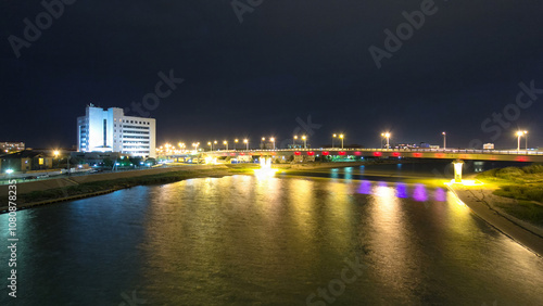 Modern houses and illuminated bridge on the riverside Ural in city Atyrau timelapse hyperlapse photo