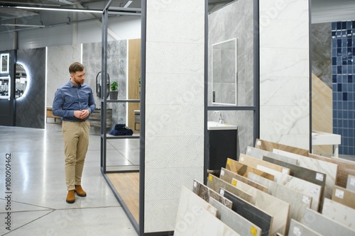 Choosing bath. Man in the store of goods for the home