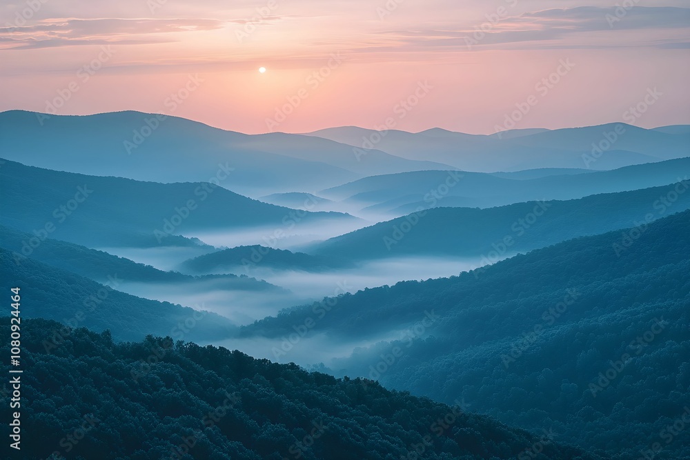 Fototapeta premium Beautiful sunrise over misty mountain valleys in early morning light