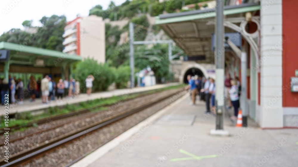 Crowd waiting on platform at train station with blurred commuters and defocused background, capturing dynamic bokeh effect in busy urban setting Crowd waiting on platform at train station with blurred commuters and defocused background, capturing dynamic bokeh effect in busy urban setting