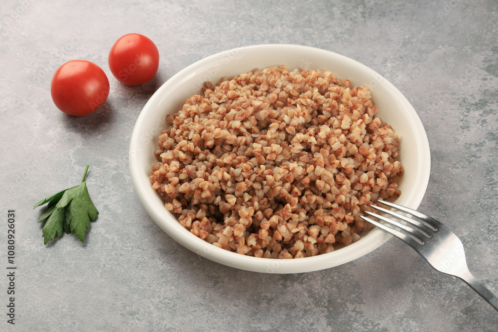 Buckwheat on a white plate - food photography. Russian food. Close up. Buckwheat on a white plate - food photography. Russian food. Close up.