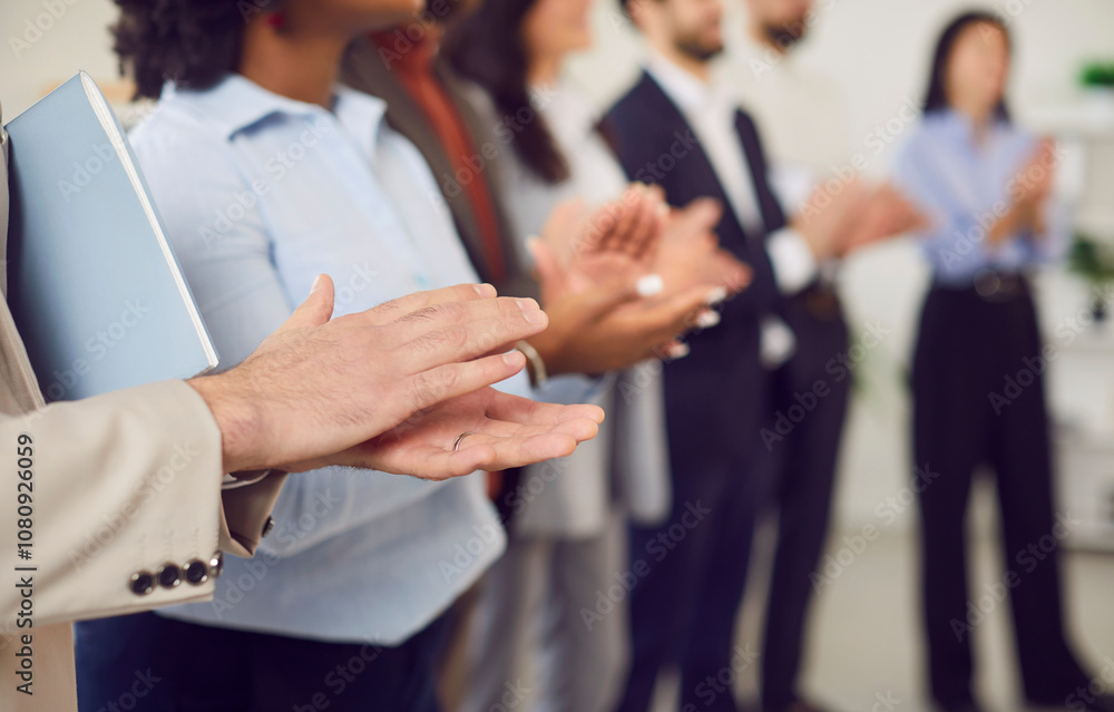 Multicultural group of business people clapping, hands close-up. Successful team standing in a row applauding, shallow focus. Concept employee appreciation day, people meeting, business success Multicultural group of business people clapping, hands close-up. Successful team standing in a row applauding, shallow focus. Concept employee appreciation day, people meeting, business success