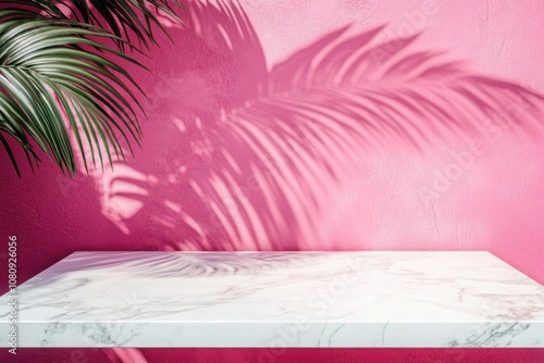 Luxury marble table with palm shadow on pink wall background.