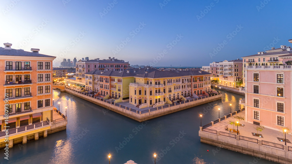 Obraz premium Canal aerial top view in Venice-like Qanat Quartier of the Pearl precinct of Doha day to night timelapse, Qatar.
