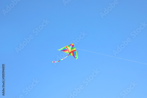 rainbow kite flying high in the blue sky symbol of carefree joy