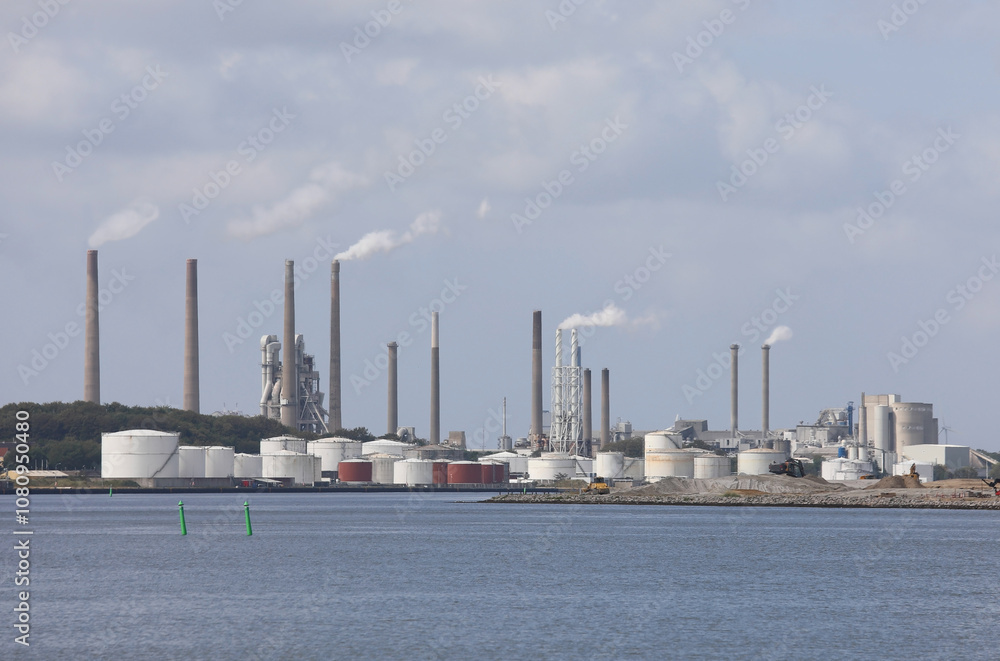 industrial plant with chimneys and fuel and gas storage tanks industrial plant with chimneys and fuel and gas storage tanks