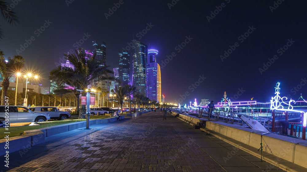 Fototapeta premium The skyline of Doha by night with starry sky seen from Corniche timelapse hyperlapse, Qatar