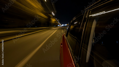 Drivelapse from side of car moving on a night avenue in city timelapse hyperlapse