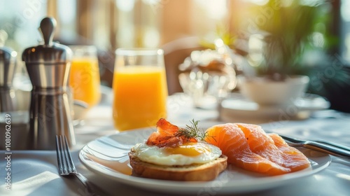 A plate of breakfast food with a glass of orange juice on a table