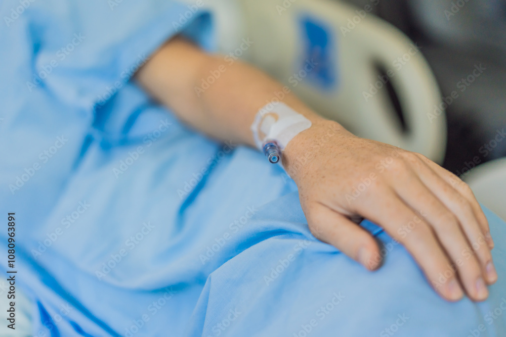 Obraz premium A woman in the hospital has a catheter inserted into her arm for IV drips. The medical procedure is performed to administer fluids, medication, or nutrients directly into her bloodstream, ensuring