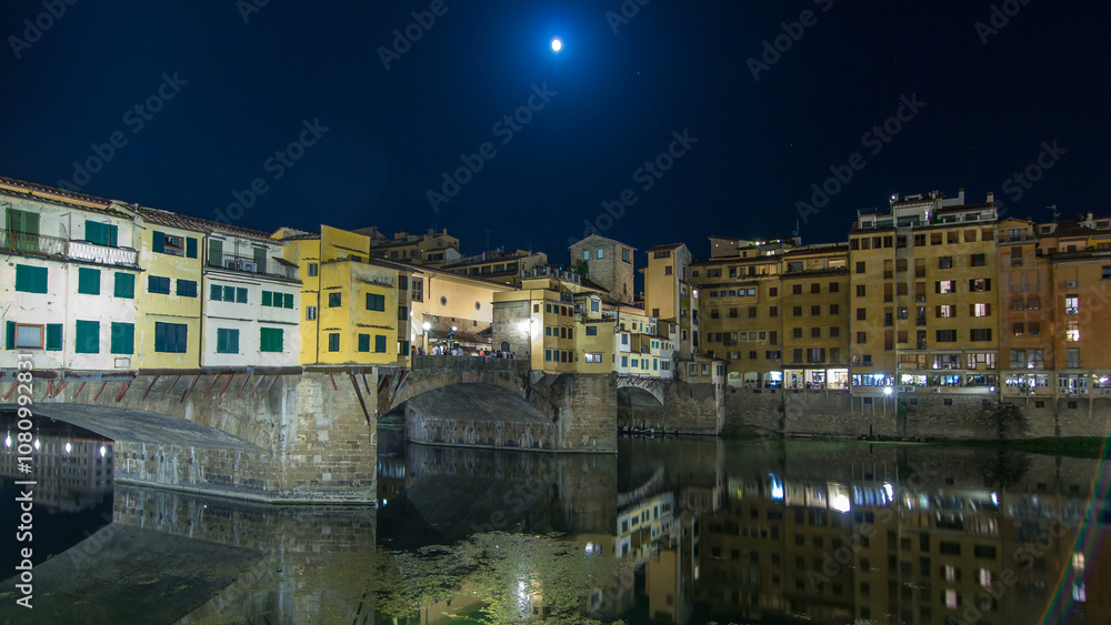 Famous Ponte Vecchio bridge timelapse hyperlapse over the Arno river in Florence, Italy, lit up at night Famous Ponte Vecchio bridge timelapse hyperlapse over the Arno river in Florence, Italy, lit up at night