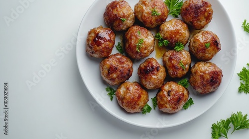 Simple plate of porkballs, neatly arranged with garnish on a white background for a clean food presentation