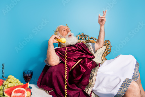 Photo of ancient mythological politician dressed traditional mantle speaking isolated on blue color background photo