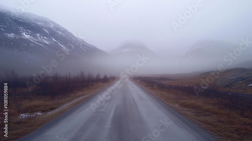 A Winding Road Fades Into Thick Fog Under a Moody Sky