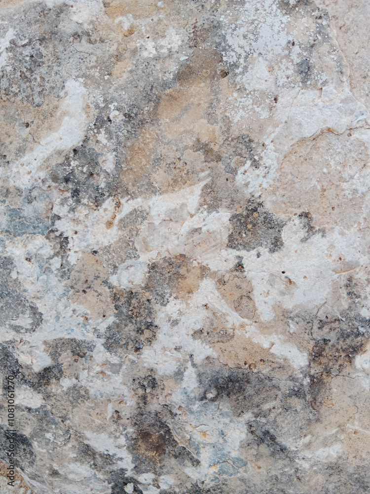 Close-up of natural stone texture with different shades of grey, brown and white. Natural cracks and patterns create a striking and unique texture. Close-up of natural stone texture with different shades of grey, brown and white. Natural cracks and patterns create a striking and unique texture.