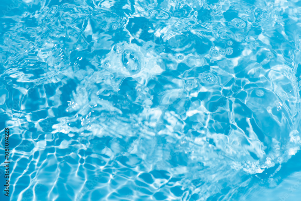 Blue water with ripples on the surface. Defocus blurred transparent blue colored clear calm water surface texture with splashes and bubbles. Water waves with shining pattern texture background. Blue water with ripples on the surface. Defocus blurred transparent blue colored clear calm water surface texture with splashes and bubbles. Water waves with shining pattern texture background.