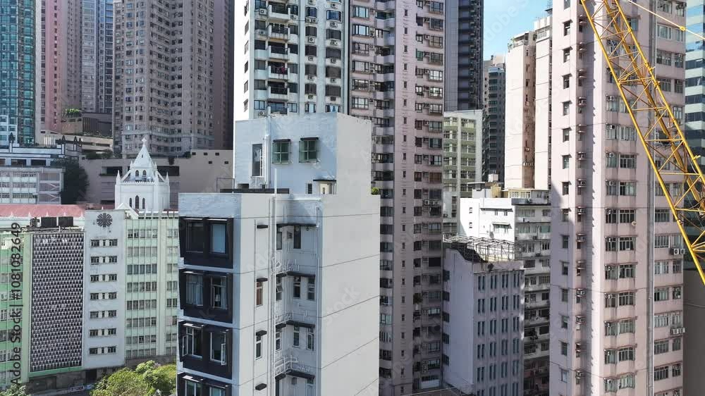 Skyview of Hong Kong Central Sheung Wan where towering skyscrapers rise amidst narrow spaces. Witness the intricate construction techniques used to build on steep slopes in this vibrant urban Skyview of Hong Kong Central Sheung Wan where towering skyscrapers rise amidst narrow spaces. Witness the intricate construction techniques used to build on steep slopes in this vibrant urban