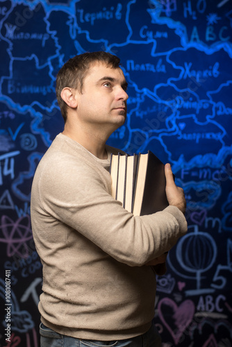 Educator holding books with a backdrop of a chalkboard map. Great for themes of learning, teaching, and academia