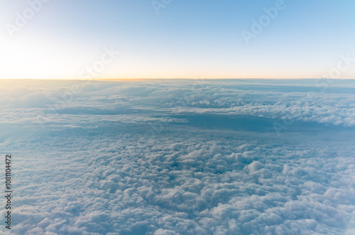 Beautiful orange and pink sunrise over the clouds, view from the plane. photo