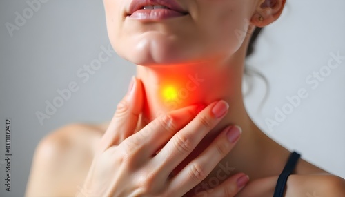 Sore throat neck, a glowing orange lights indicates a health issue in the neck area photo