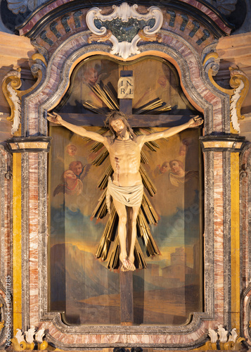 PAVIA, ITALY - SEPTEMBER 8, 2024: The carved polychrome Crucifixion in side chapel of Cathedal designed by Lorenzo Cassani (1768). photo