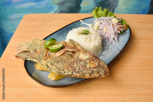 fried fish, with rice, yucca and salad, delicious food