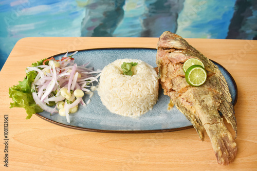 fried fish, with rice, yucca and salad, delicious food photo