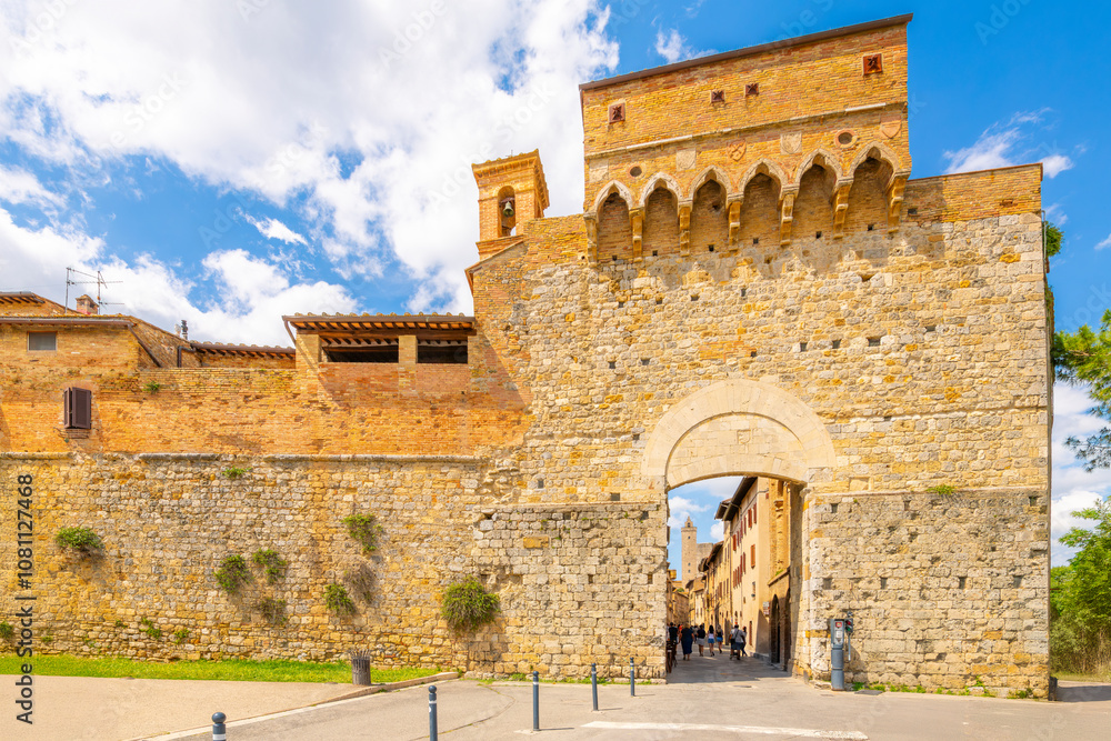 Naklejka premium The Porta San Giovanni, the main gate entrance into the Italian medieval hill town of towers, San Gimignano, Italy, in the Tuscany region.