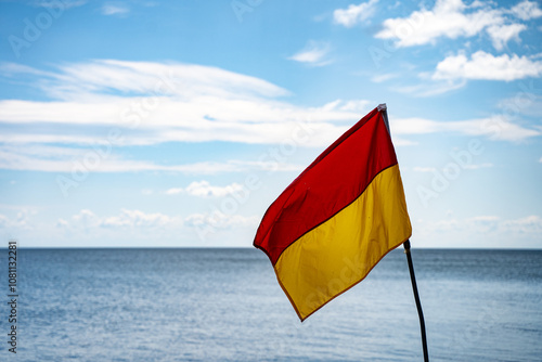 Photography View of beach and yellow red lifeguard flag
