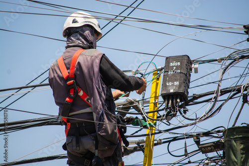 man working in safety clothing with electric light cables