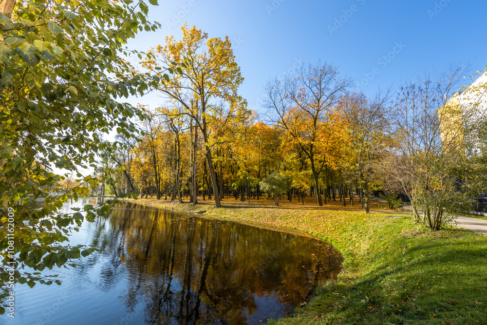 A park with a lake and trees in the background A park with a lake and trees in the background