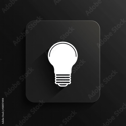 Light bulb icon on black square button, surrounded by modern office gadgets, suggests innovative solutions.