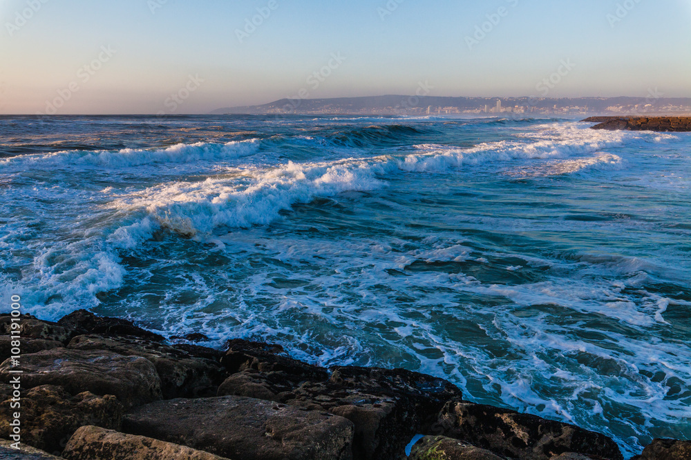 beauty and power of ocean waves rolling in during sunset. The foreground is dominated by large, foamy waves crashing toward the shore, each wave rich with texture and energy. beauty and power of ocean waves rolling in during sunset. The foreground is dominated by large, foamy waves crashing toward the shore, each wave rich with texture and energy.