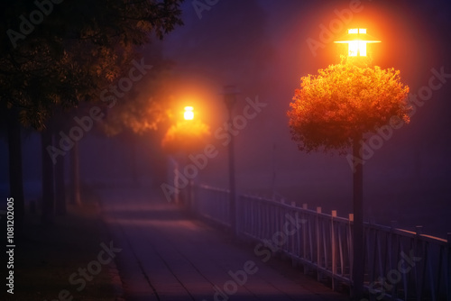 Straßenlaternen glühen in der Dunkelheit und dem Nebel am Ufer vom Süßen See photo