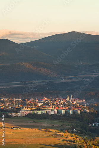 Obraz na płótnie Bystrzyca Klodzka, a small town in a mountain valley, a view of the city's buildings from the hiking trail in the Bystrzyckie Mountains. Landscape in the evening. w salonie