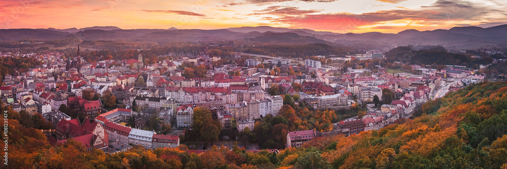 Walbrzych, sunset with a view of the city center and the Walbrzych Mountains. View of the city from the observation tower in Jan Sobieski Park, colorful autumn evening.