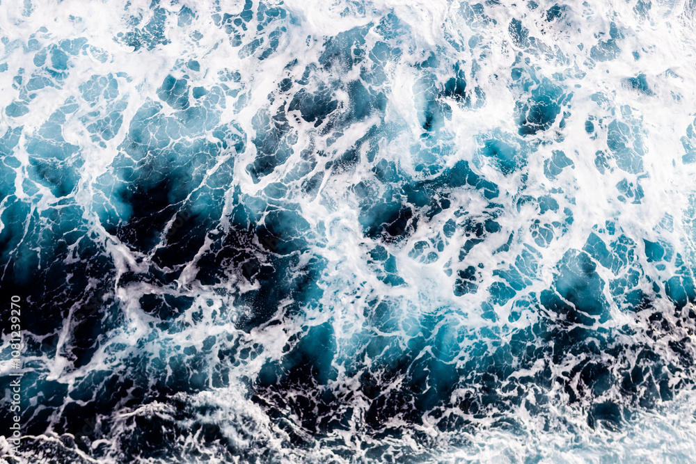 Sea water surface texture. Aerial view of elegant water with foam. Can be used in covers, packaging, posters, textures, brochures, art and design projects. Beautiful nature background image. Sea water surface texture. Aerial view of elegant water with foam. Can be used in covers, packaging, posters, textures, brochures, art and design projects. Beautiful nature background image.