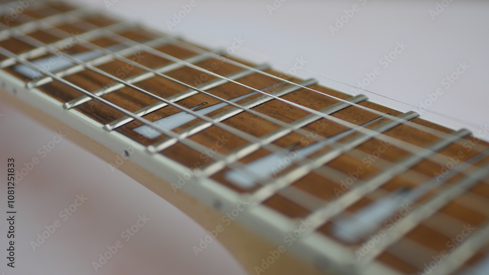 Guitar pick on strings of black electric guitar
Guitar pick on strings of black electric guitar