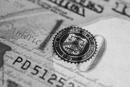 Black and white photo, close-up view, banner, of a 100 US dollar bill with intricate details, security features and vibrant colors. For finance, banking and wealth themes