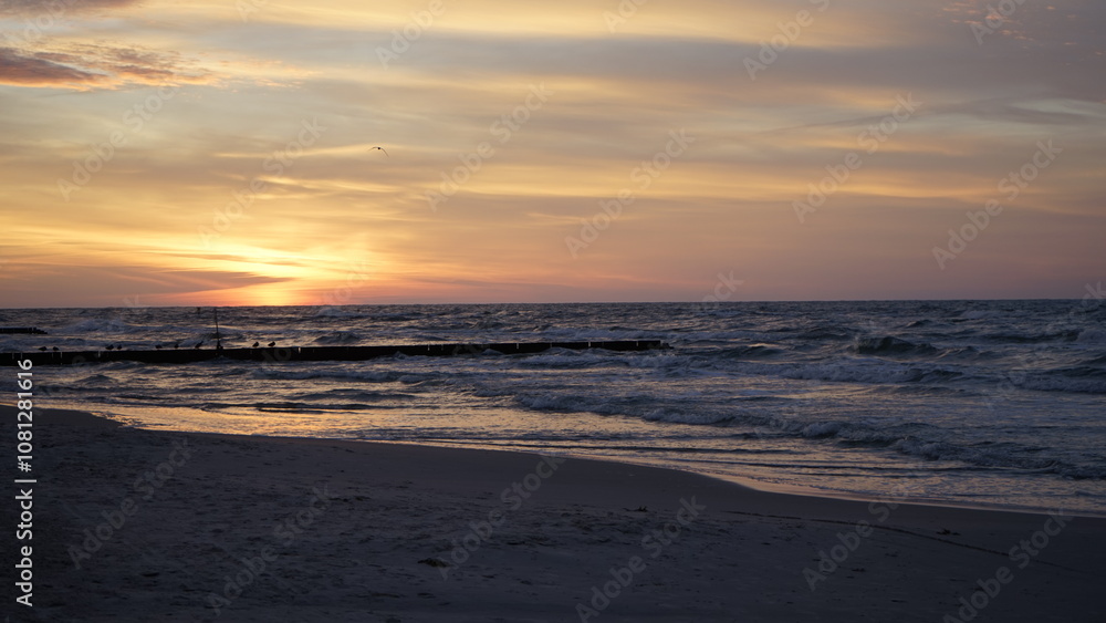 Fototapeta premium Sunset on the beach by the sea