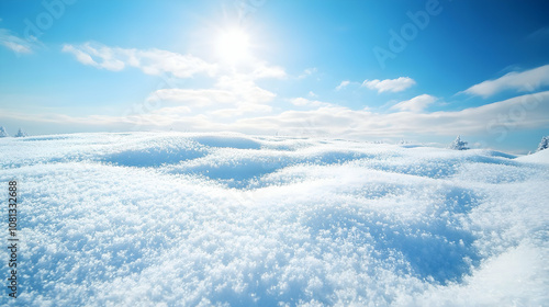 Expansive snow-covered field under a clear blue sky, with sunlit clouds adding a touch of serenity. high quality