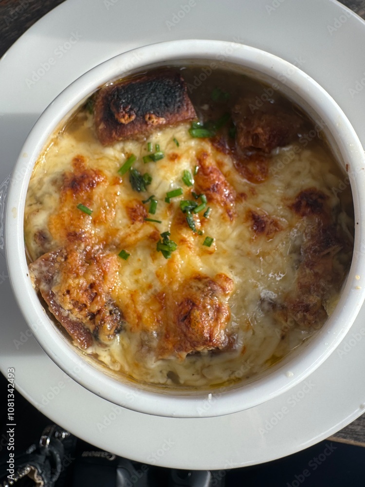Top view of French onion soup garnished with parsley Top view of French onion soup garnished with parsley