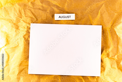 blank white sheet of paper on brown background blank sheet of plans for meetings and events for the month august