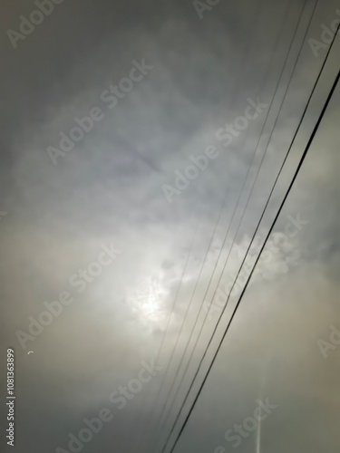 Misty Sky with Power Lines and Diffused Sunlight