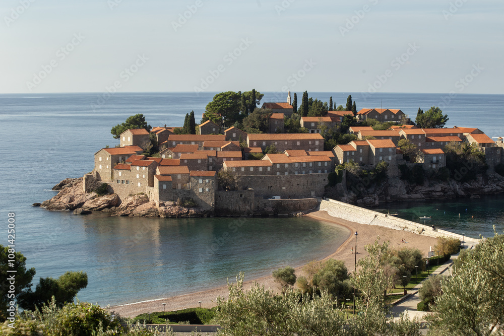 Fototapeta premium Panoramic view of island Sveti Stefan, Budva, Adriatic Mediterranean Sea, Montenegro. Summer vacation in exclusive luxury hotel complex resort at the seaside. High quality photo