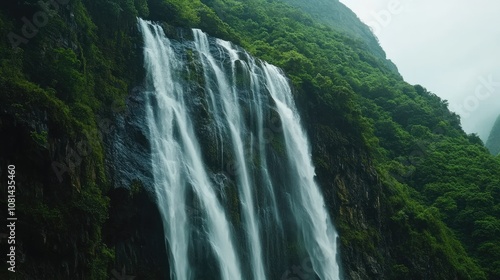 Majestic Waterfall Cascading Down Lush Green Mountains