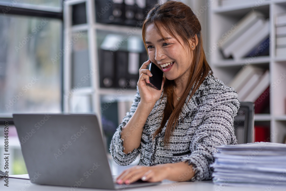 Asian business woman using calculator and laptop for doing math finance call phone at the office desk, tax, report, accounting, statistics, and analytical research concept. Asian business woman using calculator and laptop for doing math finance call phone at the office desk, tax, report, accounting, statistics, and analytical research concept.